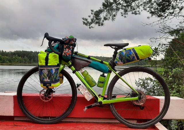 A kit of bags on a bicycle on a river background