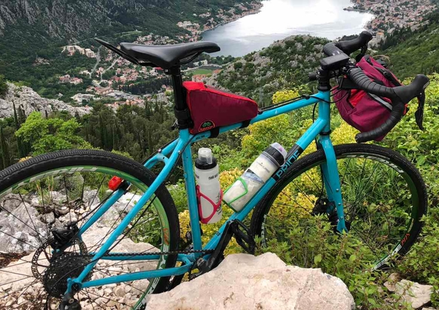 A kit of bags on a bicycle on a river background